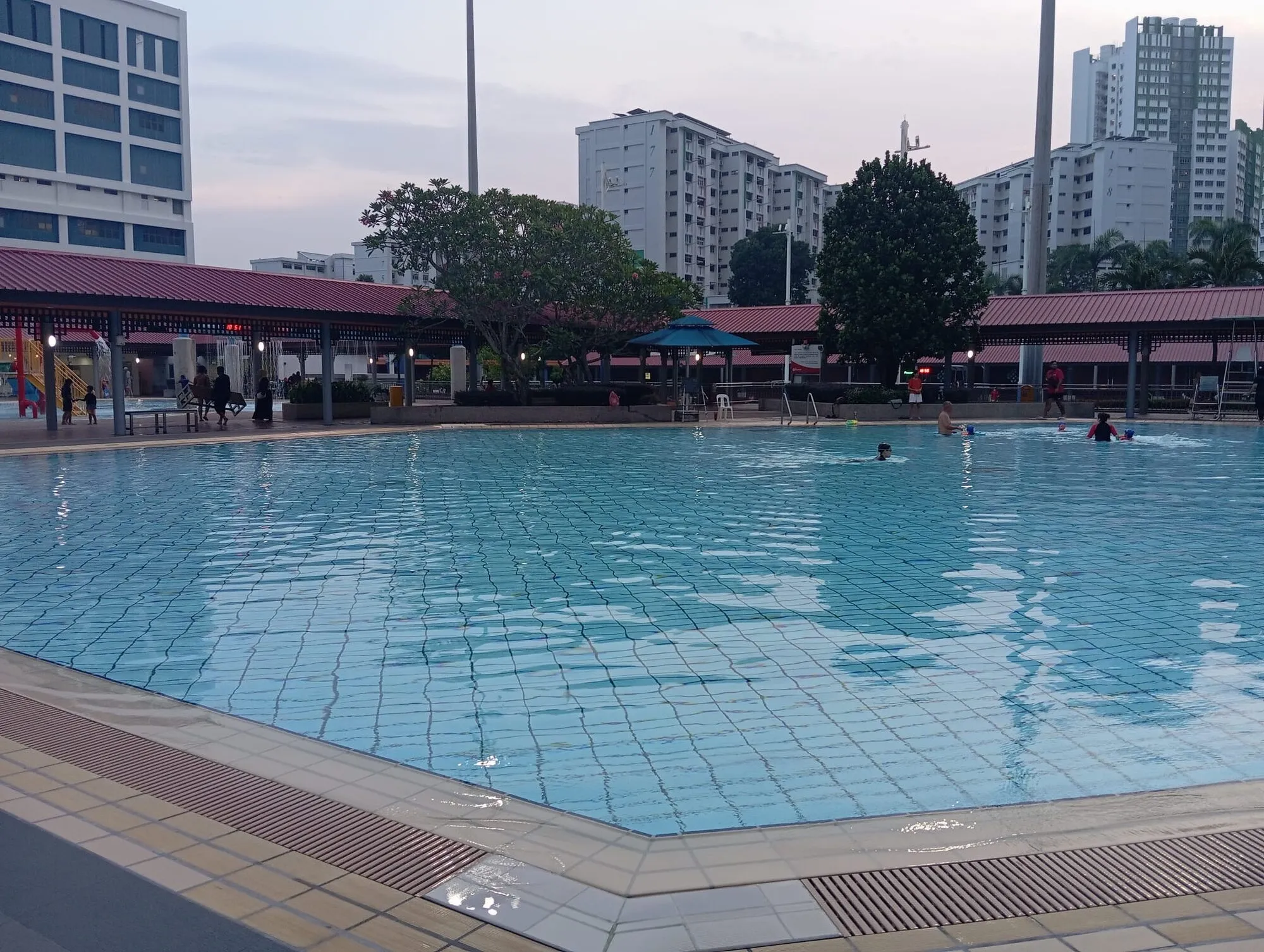 The teaching pool with red-roofed pavilions and the water playground in the background